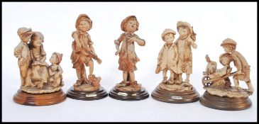 A selection of capodimonte style figurines to include a selection of street urchins having