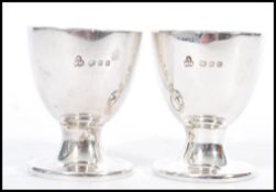 A pair of silver hallmarked egg cups. London assay mark with makers marks for Wakely & Wheeler.