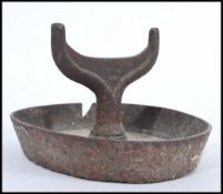 A 19th century cast iron boot scraper of architectural form raised on oval high sided base with