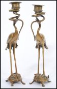 A pair of 19th century bronze candlesticks in the form of Chinese cranes stood on turtles with snake
