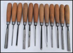 A set of twelve vintage woodworkers Chisels by Addis, all the chisels of differing size and shape