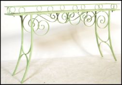 A vintage 20th century cast metal garden planter of scrolled form having painted wooden top.