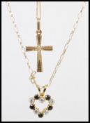 Two 9ct gold necklaces to include a crucifix pendant with a spring ring clasp, and a heart pendant