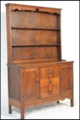 A vintage early 20th century country oak Welsh dresser base having a configuration of drawers and