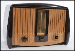 A vintage retro early / mid 20th Century bakelite valve radio by GEC with a labelled dial Medium and