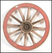 A 19th century wrought iron bound cartwheel of typical from having central iron wheel mount with