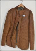 A gentleman's fashion brown leather suede quilted jacket by Blue Harbour having a corduroy collar,