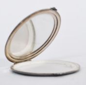 A silver hallmarked mirror by Adie Brothers Ltd compact of circular form having engine turned