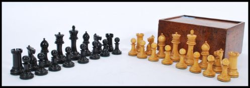 A vintage early 20th century boxwood and ebony chess set complete in sliding chess box.
