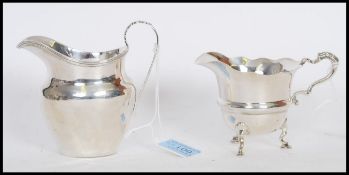 Two silver hallmarked cream jugs by George Nathan & Ridley Hayes to include one on pad feet with a