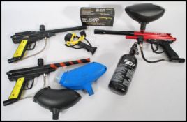 A group of paint balling equipment to include Paradox gun, Piranha Field Marker gun, PMI gun,