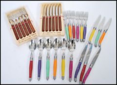 A set of French cutlery by Laguiole to include six knives and six forks with teak handles along with