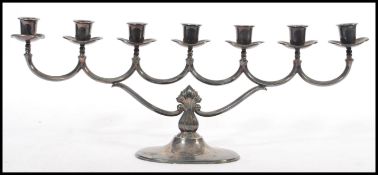 A silver hallmarked 20th Century Danish / Norway 830S menorah, with scrolled branches raised on a