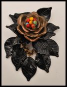 A 1940s early Miriam Haskell large dangle brooch having copper colour metal flower with coloured