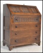 A Jaycee / Old Charm style oak bureau desk with linen fold decoration to the bureau with bank of