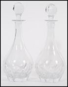 A pair of vintage 20th century cut glass crystal leaded decanters having faceted bulbous bodies with