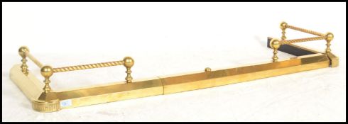 A 19th century Victorian brass adjustable kerb fire fender guard having metamorphic action and