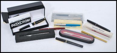 A collection of vintage fountain pens and ballpoint pens to include Parker, Conway Stewart,