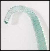 A 19th Century Nailsea glass walking stick of shaped tapering form having a twisted design. 114cm