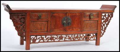 A vintage 20th century Chinese hardwood Pagoda top desk cabinet of alter shape with a