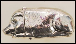 A stamped sterling silver vesta case in the form of a pig having a match striker to the base and