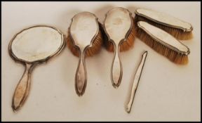 An early 20th century silver hallmarked dressing table set by Charles Henry Dumenil consisting of