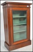 An Edwardian mahogany pier - display cabinet. Of pedestal form being raised on a plinth base with