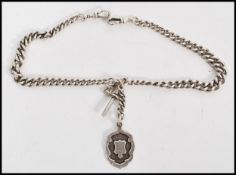 An early 20th century silver hallmarked albert chain having a T bar clasp with armorial pendant fob.