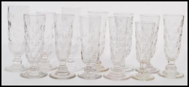 A selection of tall flute glasses / rummers with some dating from the late 19th Century, on round