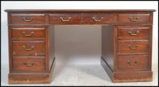 A 20th Century mahogany twin pedestal partners desk, having an arrangement of nine drawers with