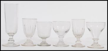 A group of six antique Georgian early 19th century drinking glasses to include a very tall example