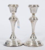 A pair of 20th century silver hallmarked candlesticks raised on circular bases with knopped stems