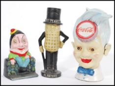 A collection of vintage 20th Century retro cast iron money boxes of advertising interest to