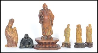 A group of Chinese carved soapstone figures dating from the 19th century to include elder wooden