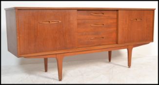 A 20th Century retro teak wood sideboard / credenza, having a central bank of three drawers