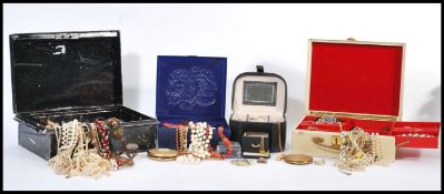 A selection of vintage costume jewellery to include simulation pearls, a stratton compact, clip on