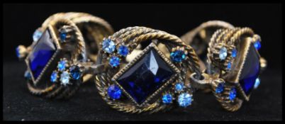A 1950s Selro Selini gold-tone bracelet and earring set being set with large faceted glass jewels