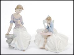 A pair of Lladro type Nao figurines of seated figures models 1355 and 1392. Printed marks to base.