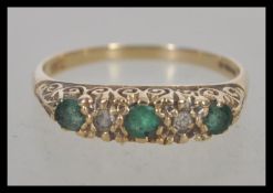 A 9ct / 375 hallmarked gold ring, the emerald approx 30 pts with approx 10 pts diamonds. Size Q.5,