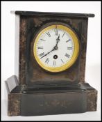 A Victorian 19th century black slate and marble 24 hour mantel clock with faceted hands and roman