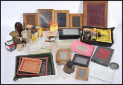 A collection of old photographic equipment in two boxes to include darkroom equipment, films,