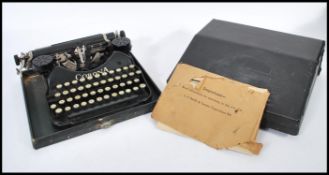 A vintage 20th Century cased Corona folding reporters typewriter, lift up lid, catches to the