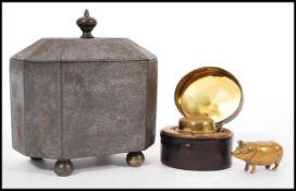 A 19th Century travelling hinged top inkwell cased with a red leather lining, a stunning brass pig