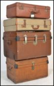 A stack of vintage 20th century to include 2 early tin tack trunks together with 2 vintage