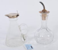 A silver hallmarked lidded glass toddy whisky miniature decanture along with a silver topped and
