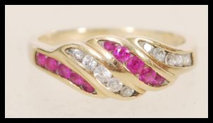 A stamped 375 9ct gold ring having pink and white stones set into the head. Weight 2.4g. Size M.5.