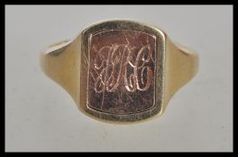 A hallmarked 9ct gold signet ring having a rectangular head with a turnable centre one side