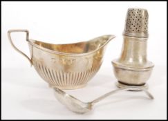 A silver hallmarked creamer jug with makers marks for Thomas Latham & Ernest Morton dating to