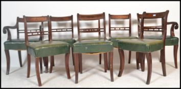 A set of 8 19th century Regency mahogany and green leather bar back dining chairs. Raised on sabre