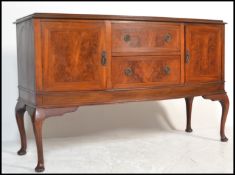 A 20th Century 1930's flame mahogany sideboard raised on cabriole legs. The bow fronted sideboard